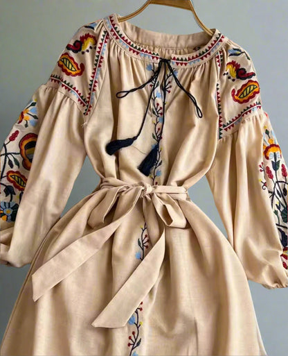 Beige embroidered midi dress, long sleeves, with adjustable tie.