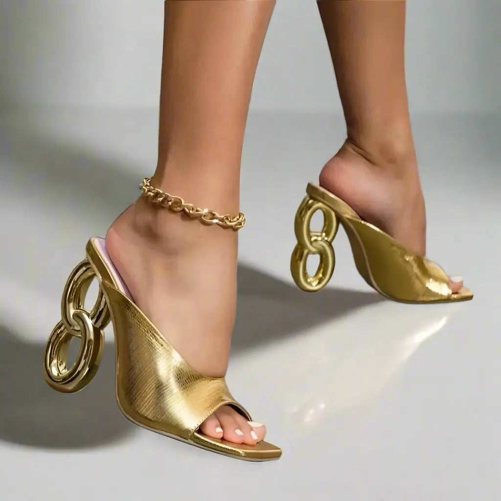 Gold high-heeled shoes with chain details
