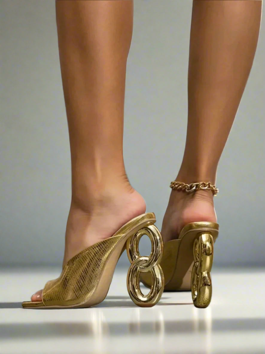 Gold high-heeled shoes with unique design