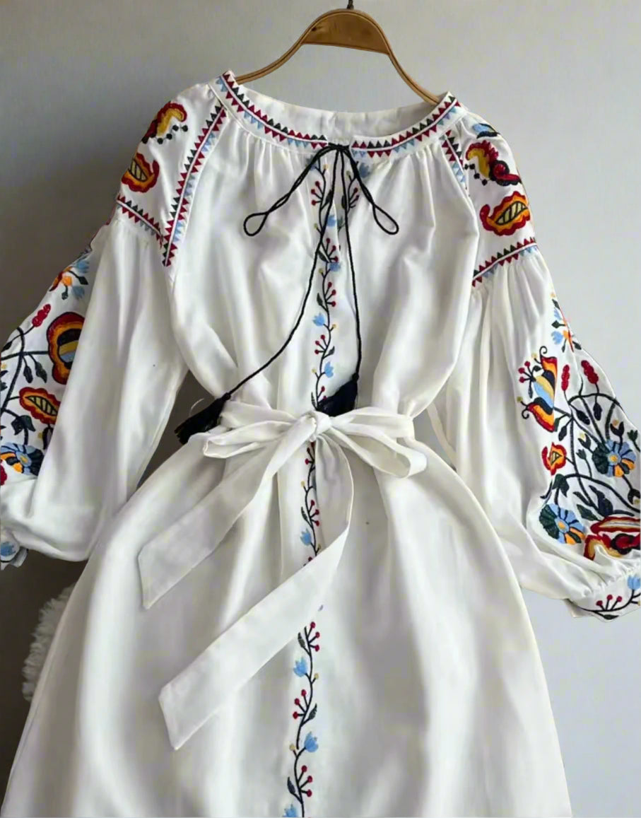 white embroidered midi dress, long sleeves, with adjustable tie